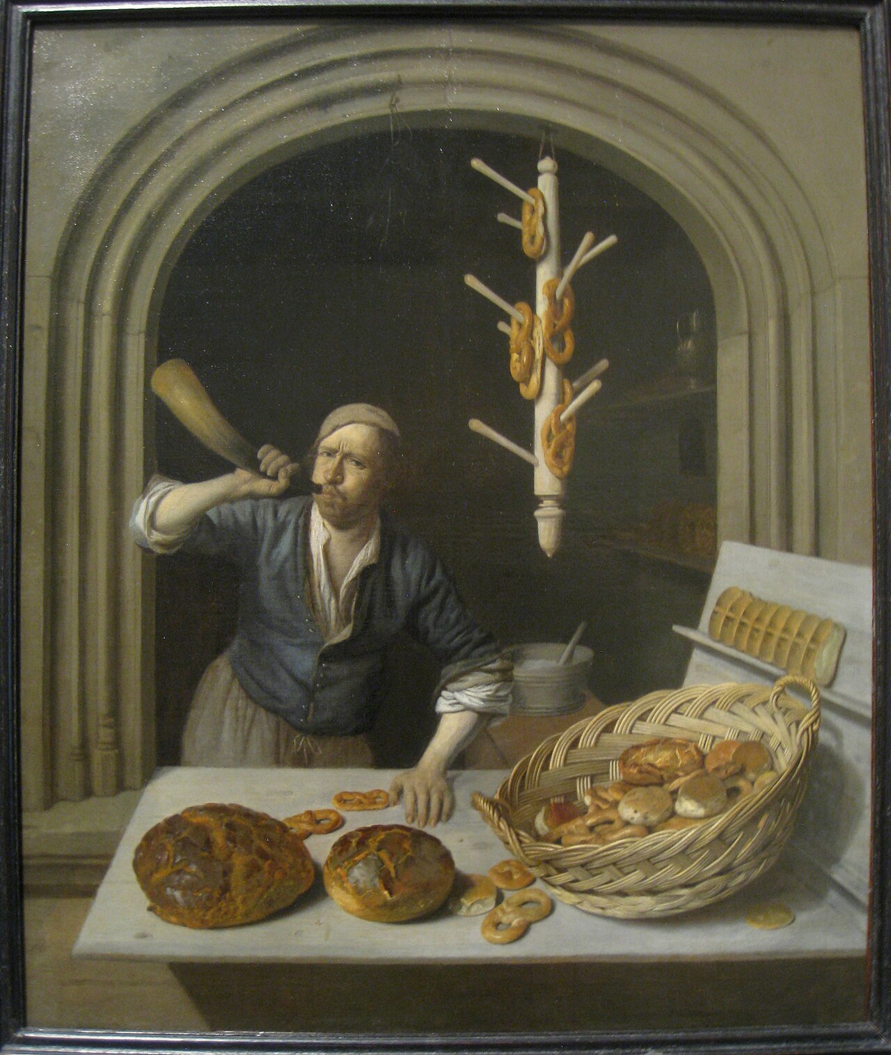 Schilderij van een bakker aan zijn toonbank met brood en pretzels